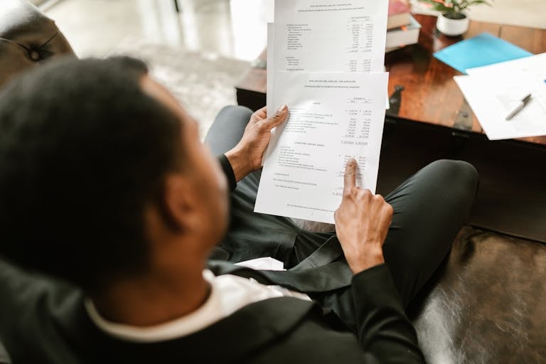 Business professional reviewing financial documents, highlighting important considerations before joining a nonprofit board, including fiduciary responsibilities.