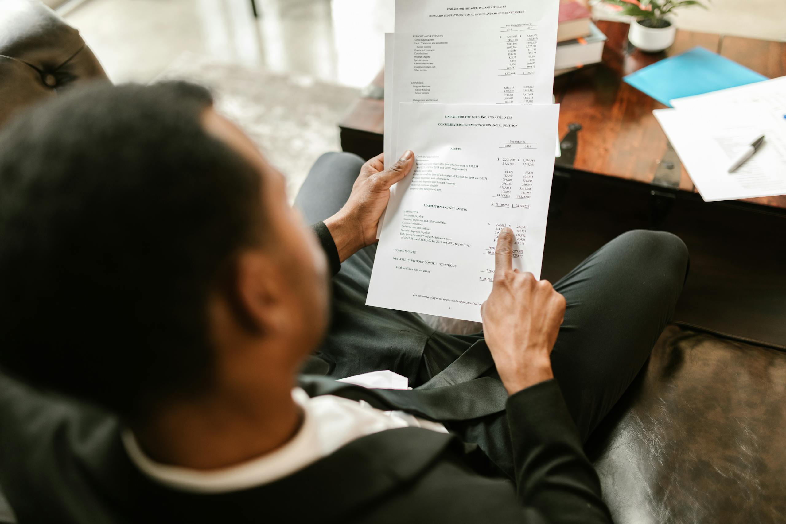 Business professional reviewing financial documents, highlighting important considerations before joining a nonprofit board, including fiduciary responsibilities.