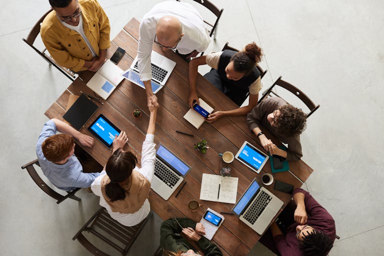 Nonprofit board meeting around a table, symbolizing the need for directors and officers liability insurance to protect leadership decisions.